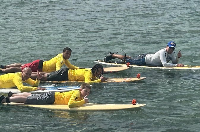 60 to 90 minutes Open Book Surfing Lesson with Certified Guide - Gear Included: Rash Guard, Reef Shoes, and a Real Leash Setup